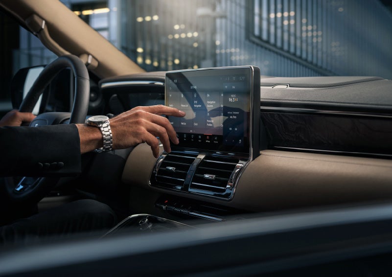 A hand is about to press the personal profiles tile on the settings screen | Stevens Creek Lincoln in San Jose CA