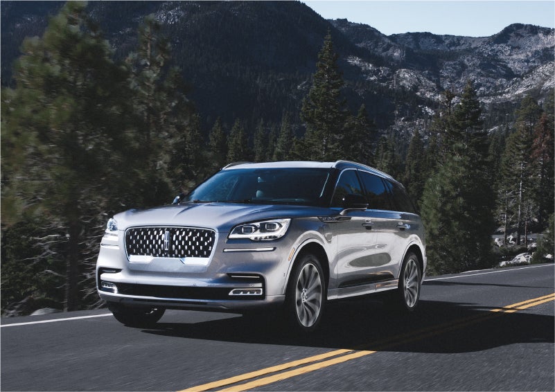 A 2023 Lincoln Aviator® Grand Touring SUV being driven on a winding road to demonstrate the capabilities of all-wheel drive | Stevens Creek Lincoln in San Jose CA