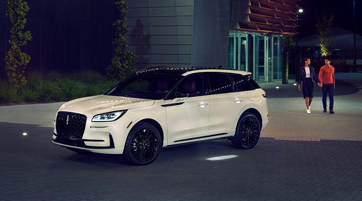 Two people approach a 2024 Lincoln Corsair® SUV featuring the available Jet Appearance Package. | Stevens Creek Lincoln in San Jose CA