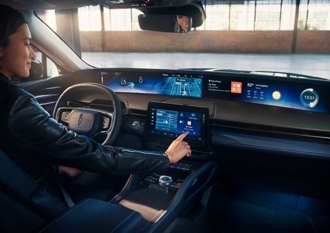 The driver of a 2024 Lincoln Nautilus® SUV interacts with the center touchscreen. | Stevens Creek Lincoln in San Jose CA