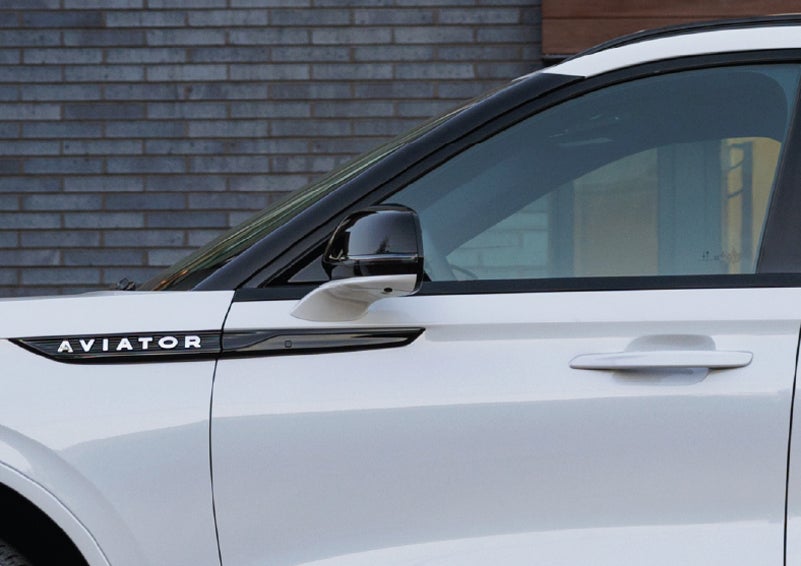 The driver’s side door and fender badging of a white 2026 Lincoln Aviator® SUV are showcased. | Stevens Creek Lincoln in San Jose CA