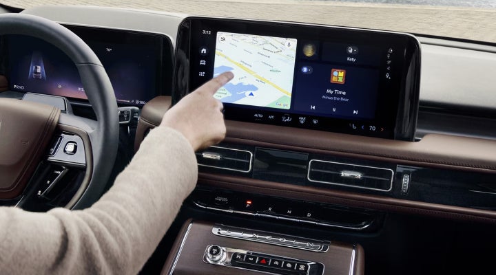 A person is tapping the center display touchscreen of a 2026 Lincoln Aviator® SUV. | Stevens Creek Lincoln in San Jose CA