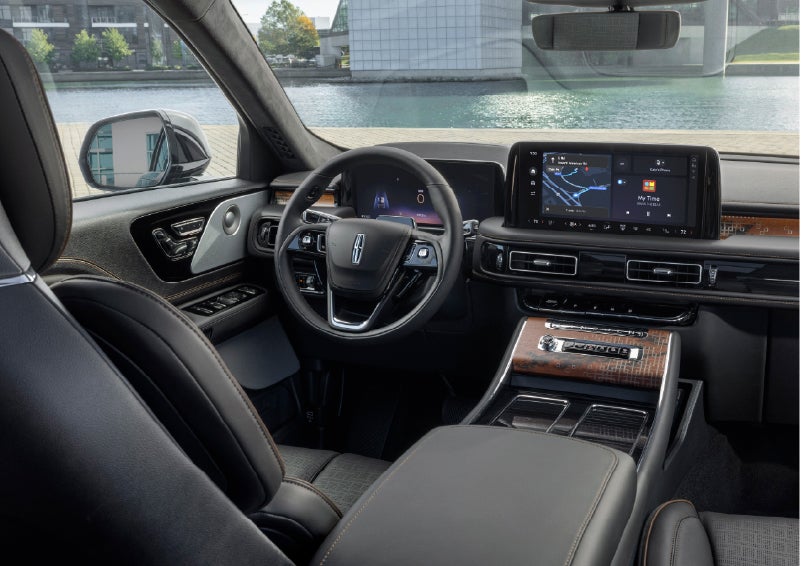 The interior of the 2026 Lincoln Aviator® SUV is shown parked with a view of a harbor through the windshield. | Stevens Creek Lincoln in San Jose CA