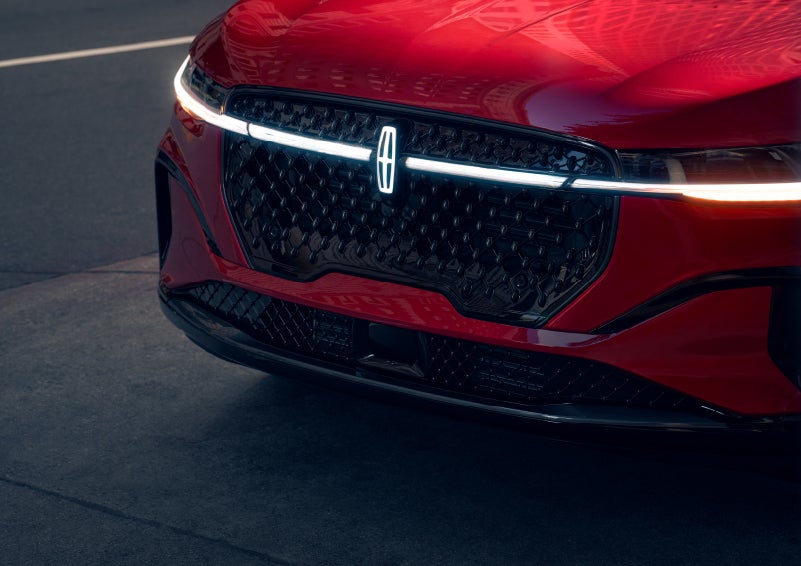 The available front LED light bar and center Lincoln Star logo glow at dusk. | Stevens Creek Lincoln in San Jose CA