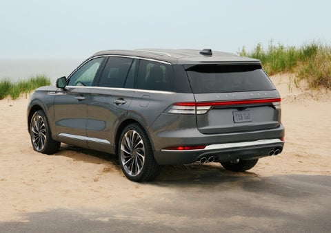 A 2027 Lincoln Aviator® SUV is parked next to sand dunes. | Stevens Creek Lincoln in San Jose CA