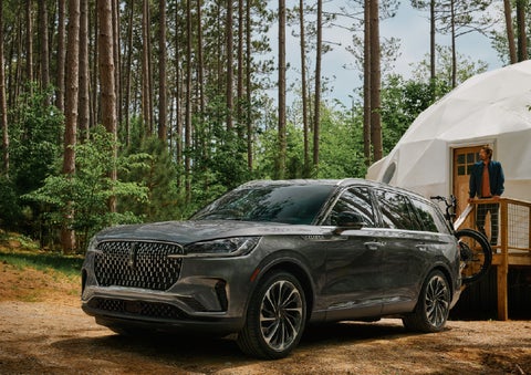 A 2027 Lincoln Aviator® is parked next to a high end glamping site. | Stevens Creek Lincoln in San Jose CA