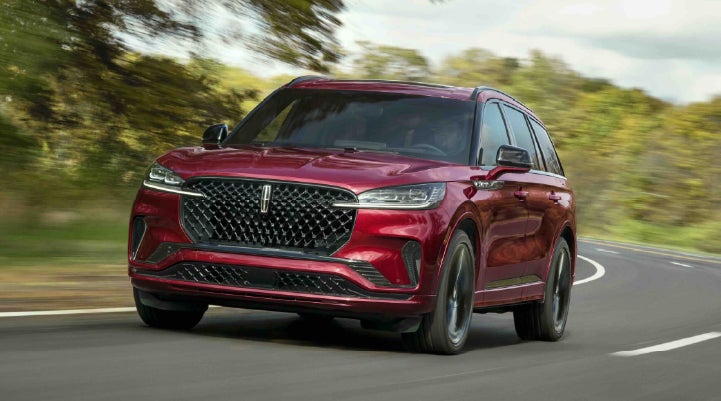 A 2027 Lincoln Aviator® SUV is being driven on a country road | Stevens Creek Lincoln in San Jose CA