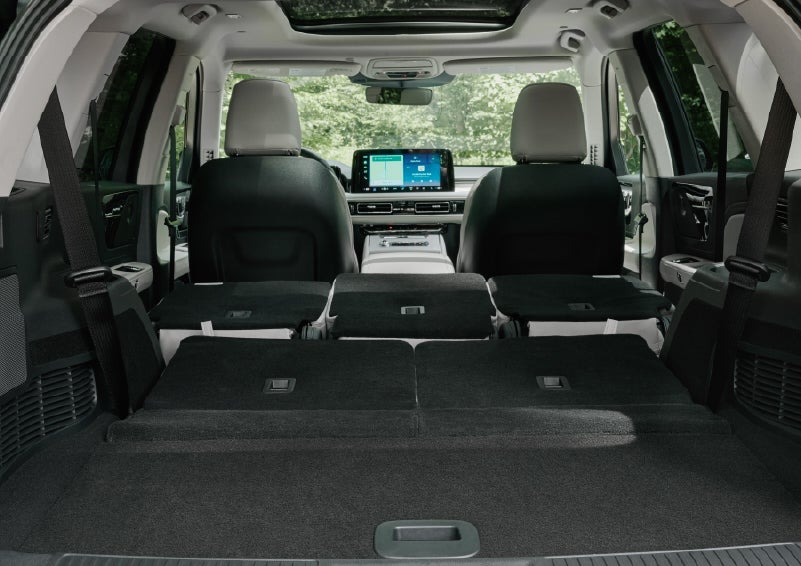 A rear to front view of the interior of a 2027 Lincoln Aviator® Black Label™ SUV shows the third and second rows folded flat | Stevens Creek Lincoln in San Jose CA