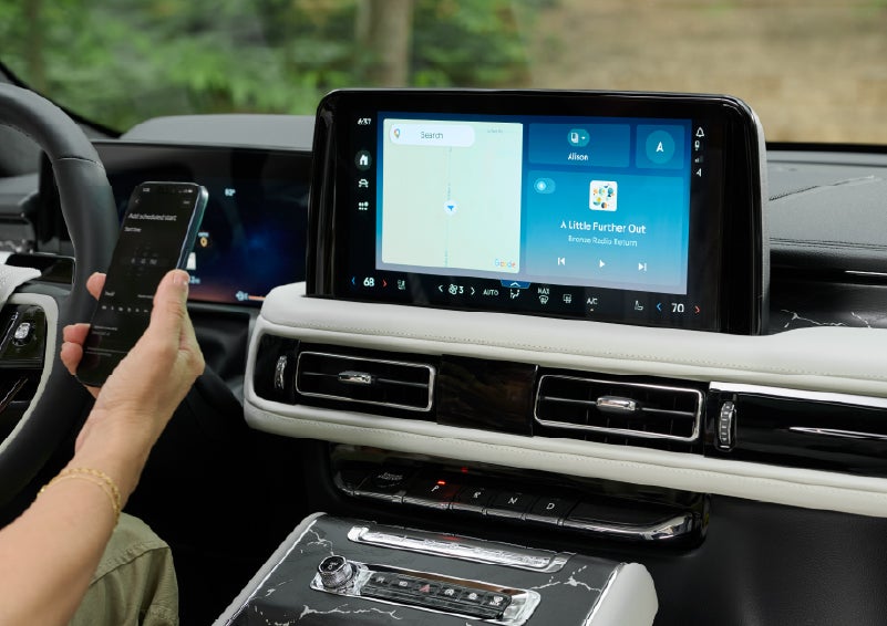 A person pairs thier phone with the center touchscreen of a 2027 Lincoln Aviator® Black Label™ SUV | Stevens Creek Lincoln in San Jose CA